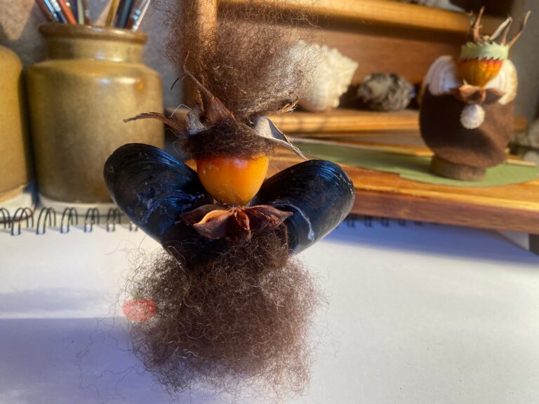 Glue more wool for the dress and hair at the crown of your nature guardian.
