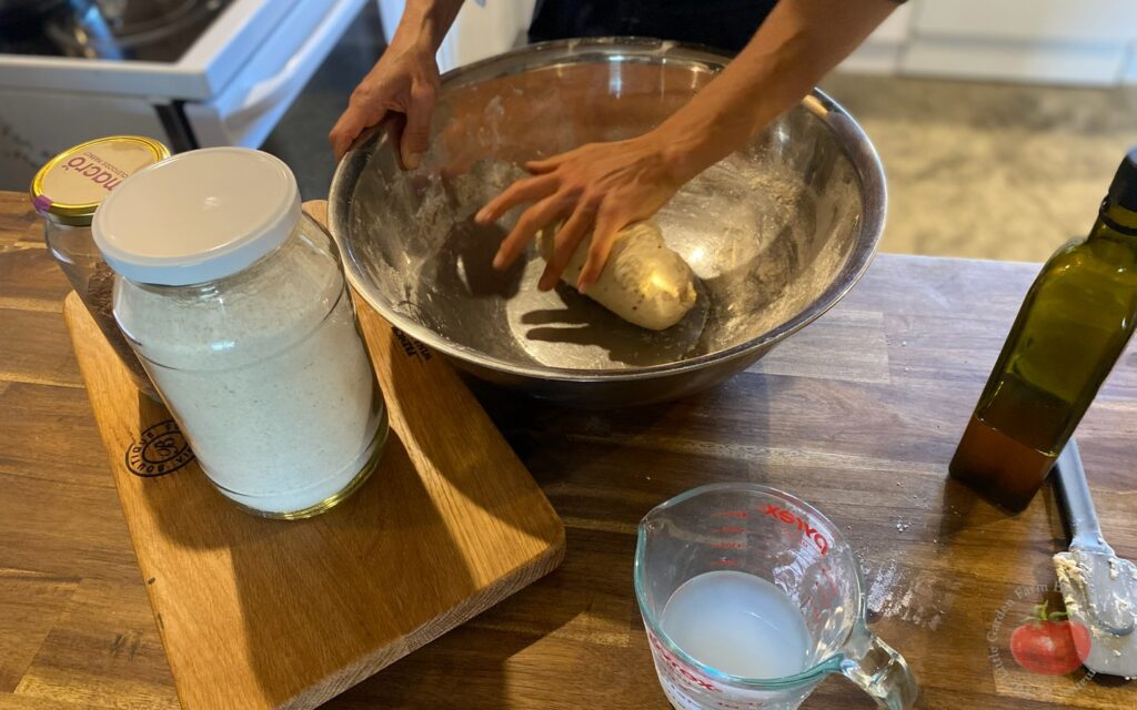 “kneading bread dough by hand rustic kitchen cabin Australia”